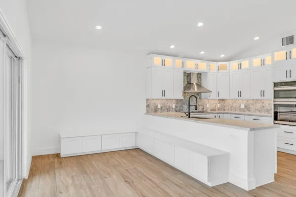a view of kitchen with furniture and wooden floor