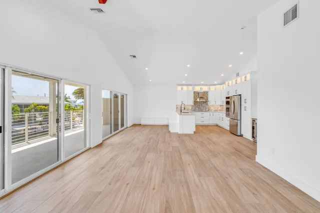 a view of a room with wooden floor