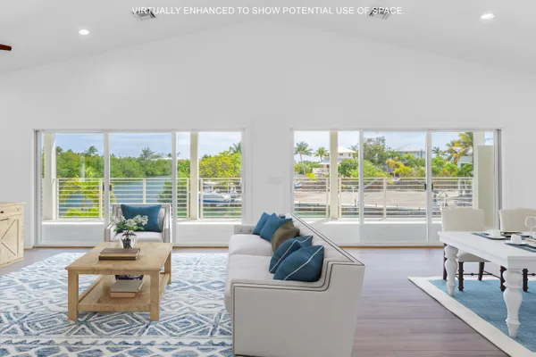 a living room with furniture and large windows