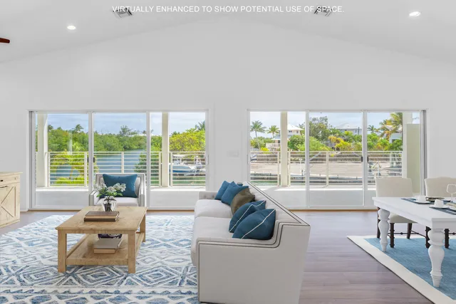 a living room with furniture kitchen view and a flat screen tv