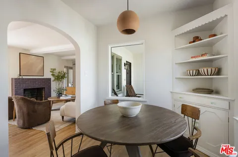 a kitchen with white cabinets and appliances