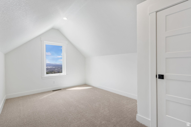 692 East Mountain Road North Ogden, UT 84414 - Photo 12 of 17 Attic room featuring a single-pane window with white trim, a recessed ceiling light, and a light-colored carpeted floor