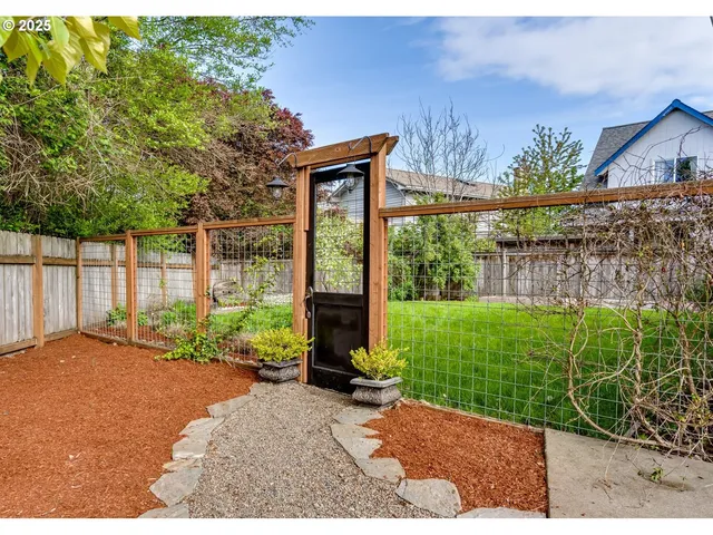 a view of a house with a garden and plants