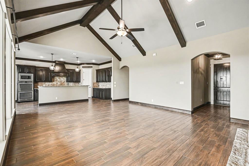 104 Stanford Lane Springtown, TX 76082 - Photo 13 of 28 a view of a big room with wooden floor and a kitchen