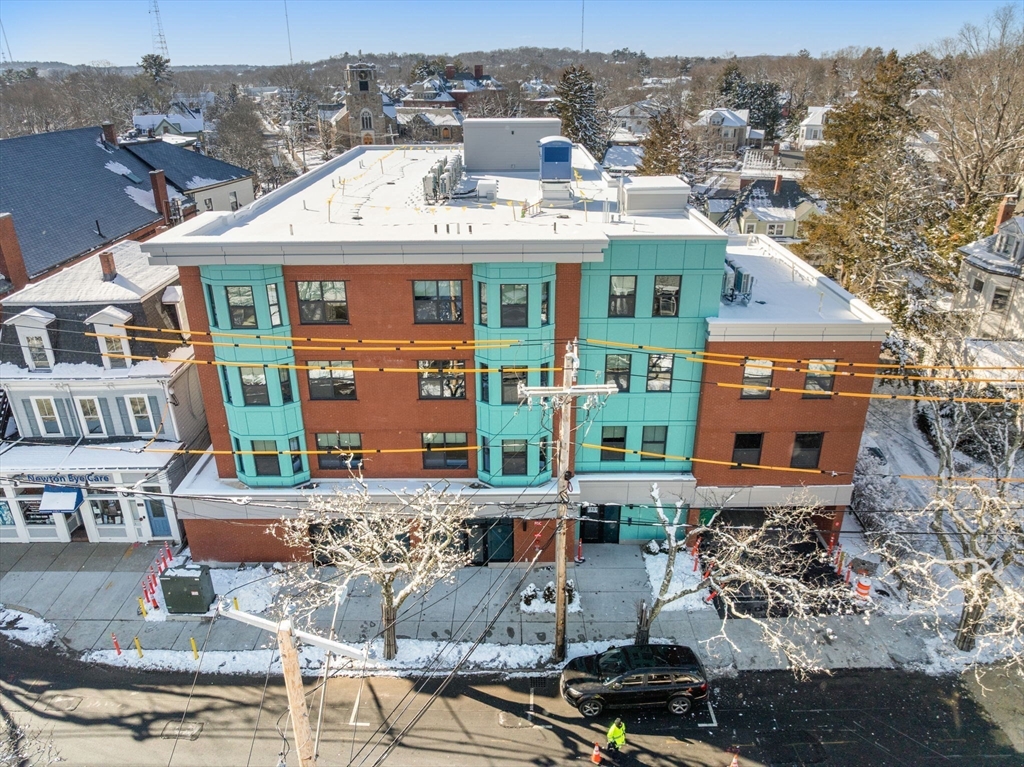1151 Walnut Street, Unit 307 Newton, MA 02461 - Photo 1 of 32 a front view of a residential apartment building with a yard