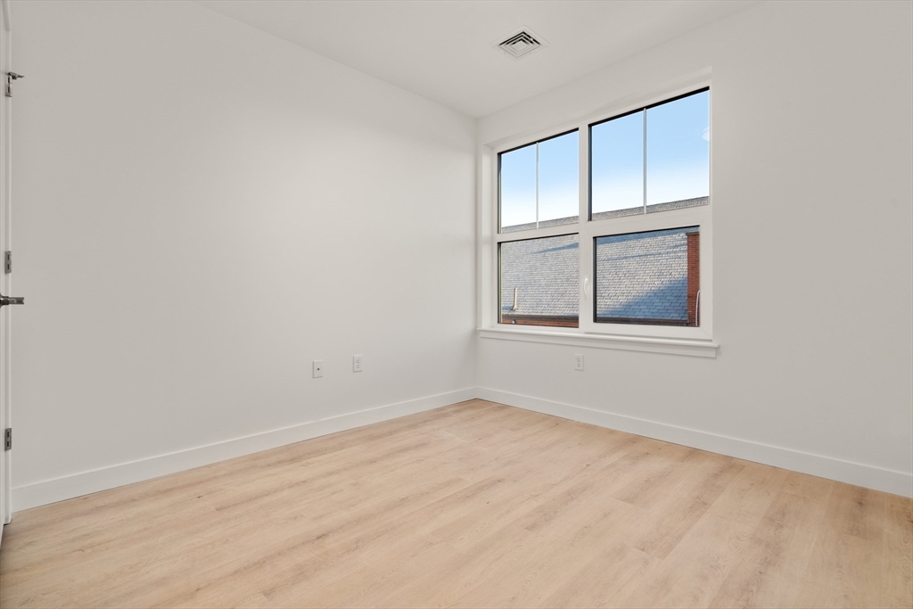 1151 Walnut Street, Unit 307 Newton, MA 02461 - Photo 17 of 32 a view of an empty room with a window