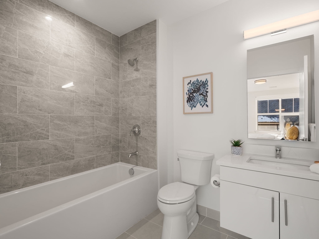1151 Walnut Street, Unit 307 Newton, MA 02461 - Photo 10 of 32 a bathroom with a sink a toilet and a bathtub