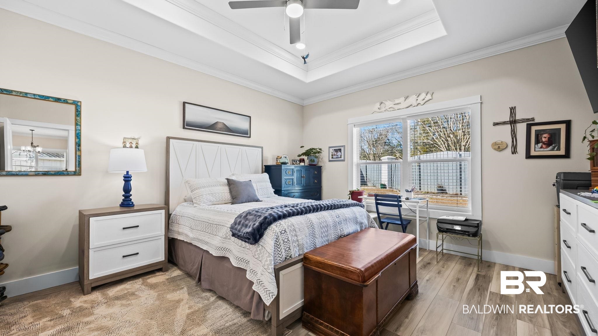 8013 Carmel Circle Foley, AL 36535 - Photo 22 of 49 Bedroom with crown molding, light wood-style flooring, ceiling fan, and a raised ceiling