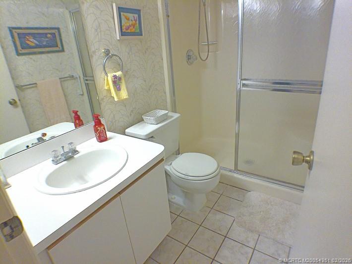 330 Southwest South River Drive, Unit 201 Stuart, FL 34997 - Photo 12 of 37 a bathroom with a sink toilet and shower