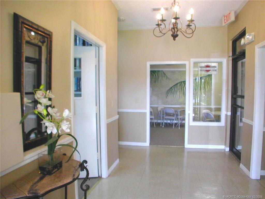330 Southwest South River Drive, Unit 201 Stuart, FL 34997 - Photo 22 of 37 a view of a dining room with furniture and a chandelier