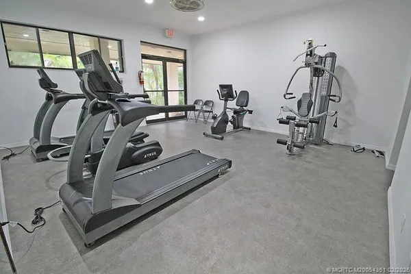 a view of a house with pool and chairs