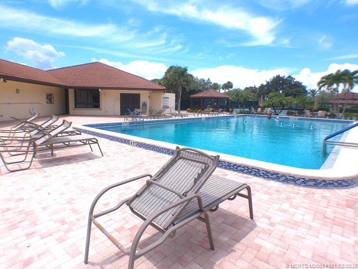 330 Southwest South River Drive, Unit 201 Stuart, FL 34997 - Photo 28 of 37 a view of a house with pool and chairs