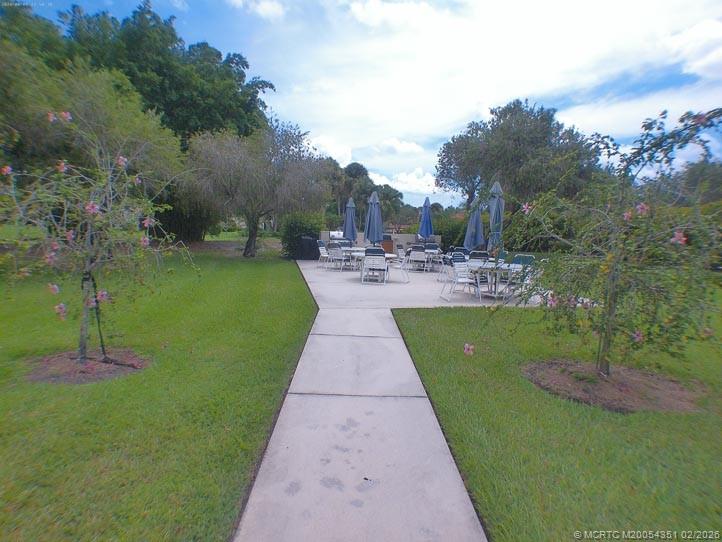 330 Southwest South River Drive, Unit 201 Stuart, FL 34997 - Photo 30 of 37 a view of a patio with chairs and a yard