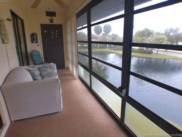 330 Southwest South River Drive, Unit 201 Stuart, FL 34997 - Photo 10 of 37 a living room with furniture and a floor to ceiling window