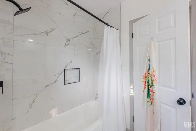 a bedroom with a bed and glass walk in closet