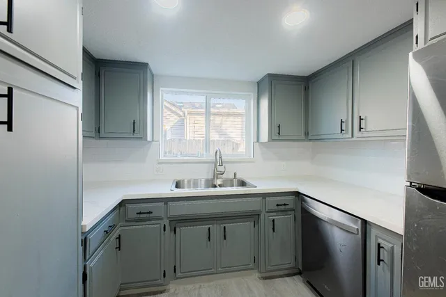 a kitchen with stainless steel appliances granite countertop a stove a refrigerator and a refrigerator