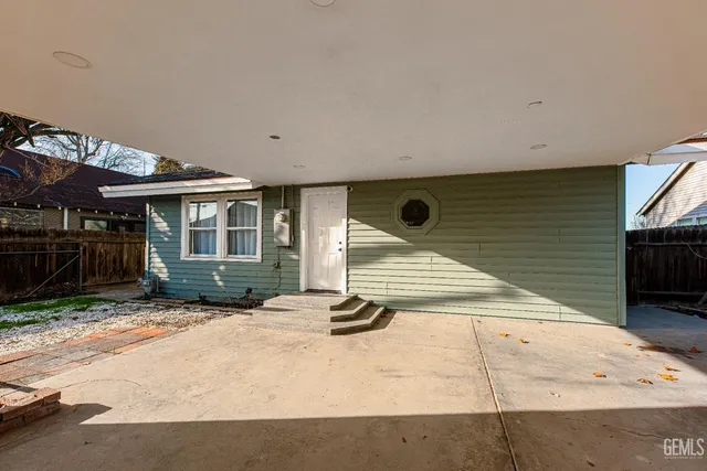 a view of a house with wooden walls and floor to ceiling window