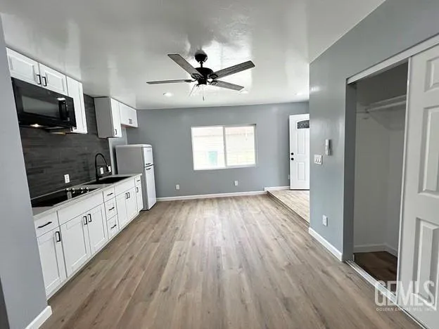 a open kitchen with cabinets a sink and stainless steel appliances