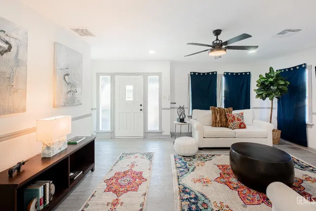 a living room with furniture and wooden floor