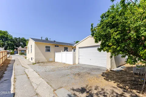 a view of a house with a backyard and a garage
