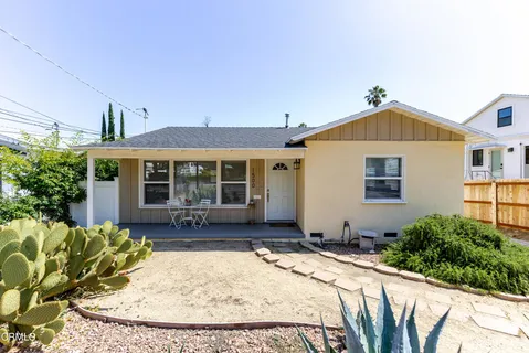 a front view of a house with a garden and patio