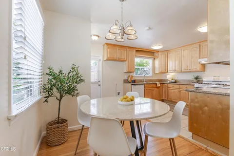 a kitchen with a table chairs and microwave