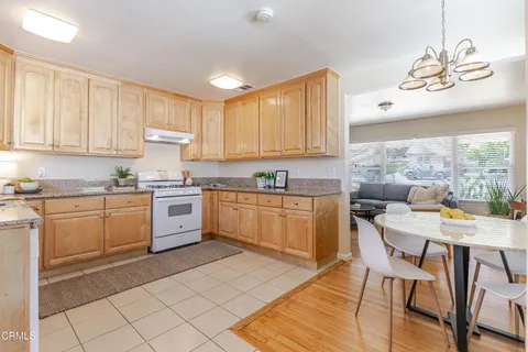 a kitchen with a stove window and cabinets