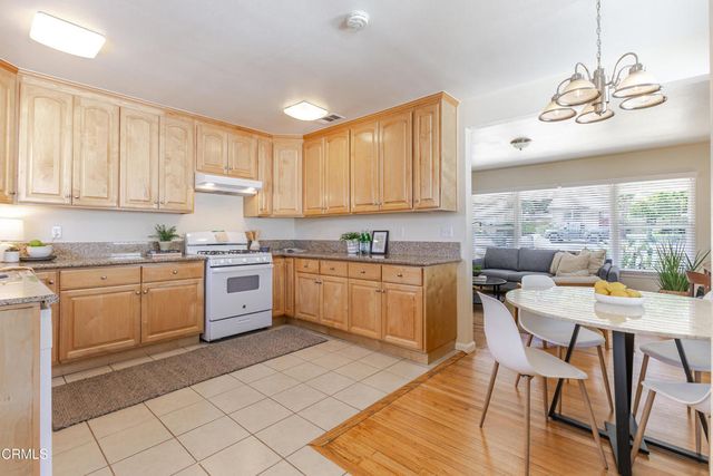 a kitchen with a stove window and cabinets