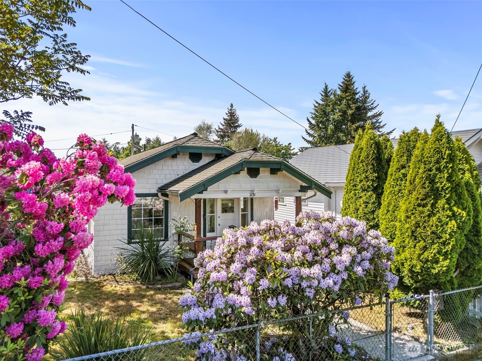 2121 5th Street Bremerton, WA 98312 - Photo 27 of 32 a front view of a house with a flower garden