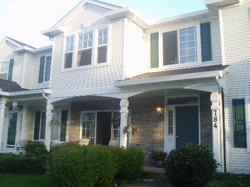 front view of a brick house with a large windows