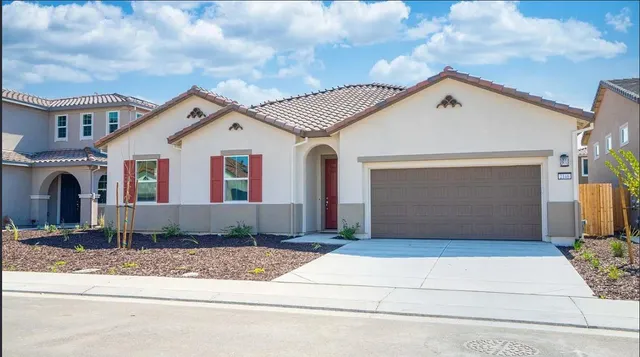a front view of a house with garage
