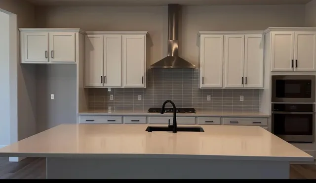 a kitchen with a sink and cabinets