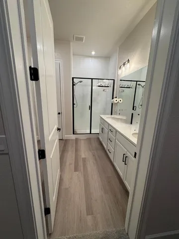 a view of a hallway with wooden floor
