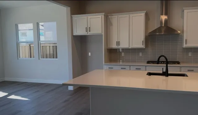 a kitchen with granite countertop a sink and a stove