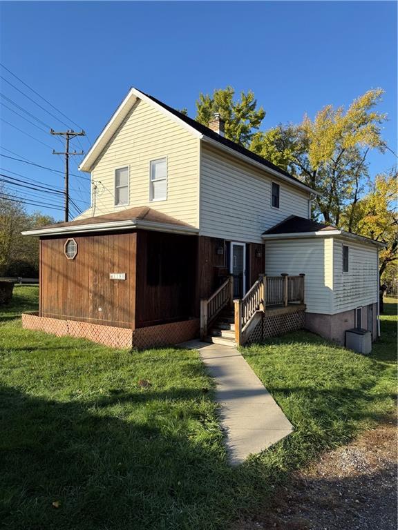 a front view of a house with a garden and yard