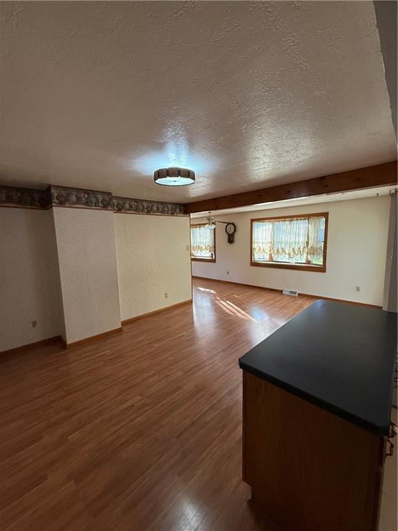 1180 Charles Street Monaca, PA 15061 - Photo 7 of 15 an empty room with wooden floor and windows