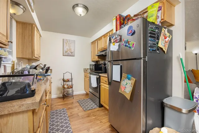 a kitchen with a refrigerator and a sink