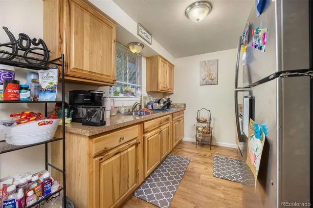 a kitchen with stainless steel appliances granite countertop a sink and cabinets