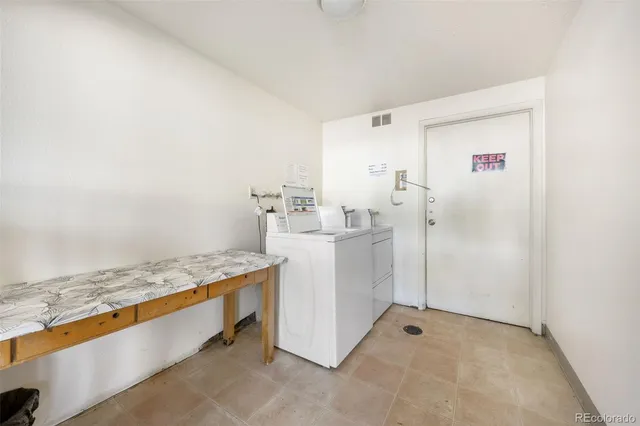 a utility room with cabinets washer and dryer