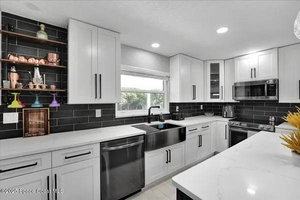 a large kitchen with a large counter top appliances and cabinets
