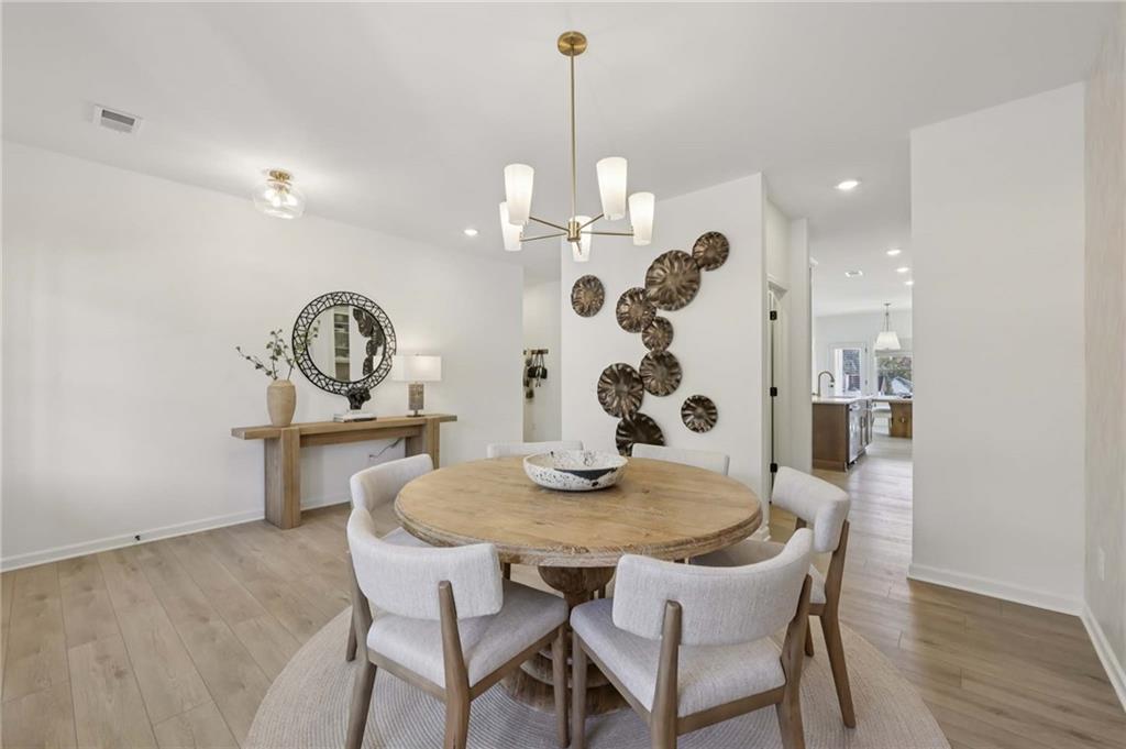 6145 Kismet Road Buford, GA 30518 - Photo 19 of 43 a view of a dining room and a table and chairs