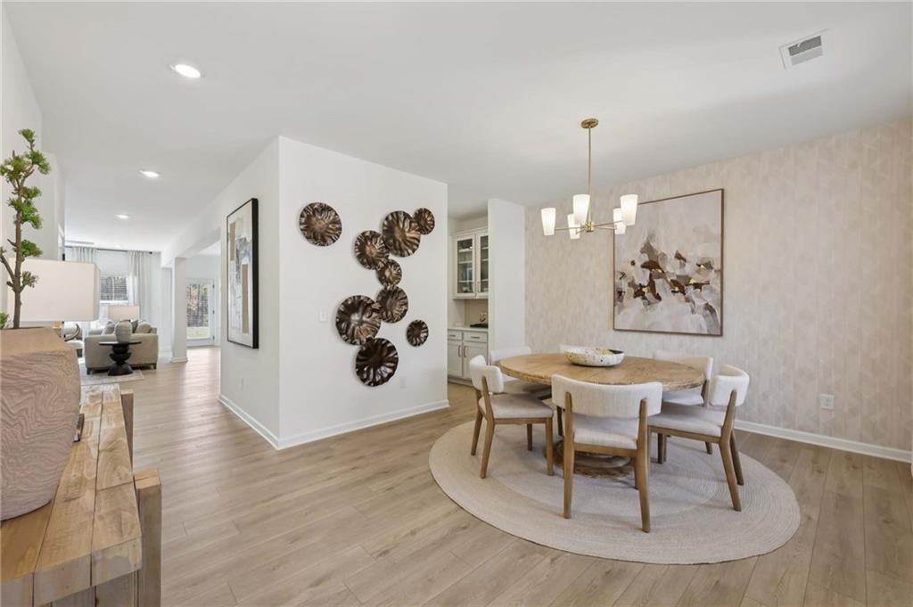 6145 Kismet Road Buford, GA 30518 - Photo 20 of 43 a view of a dining room with furniture and chandelier