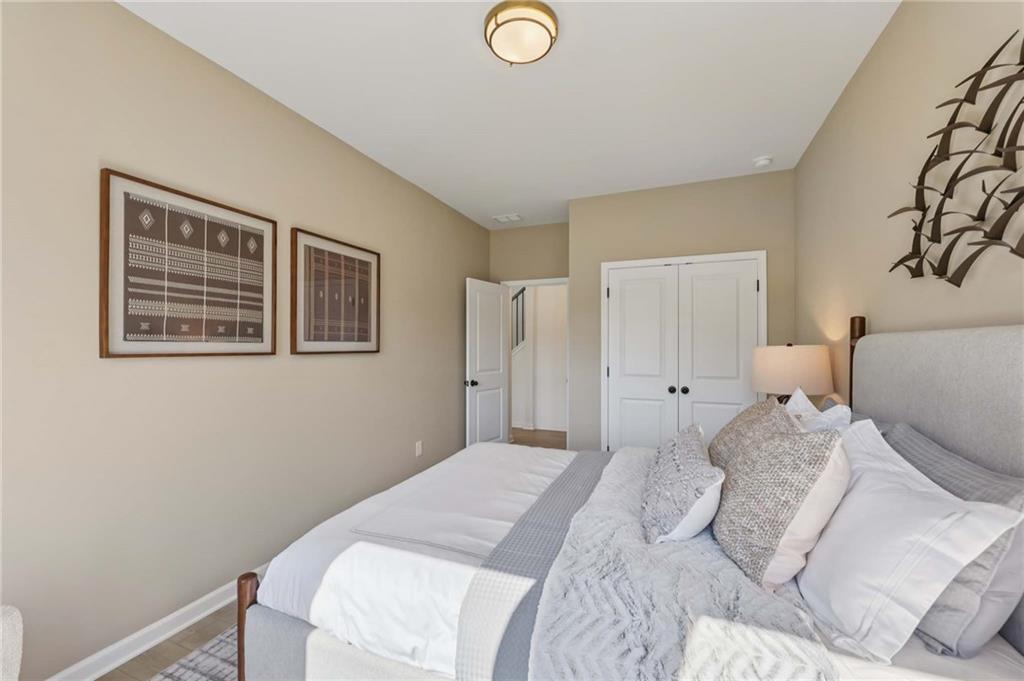 6145 Kismet Road Buford, GA 30518 - Photo 24 of 43 a bedroom with a bed and a lamp