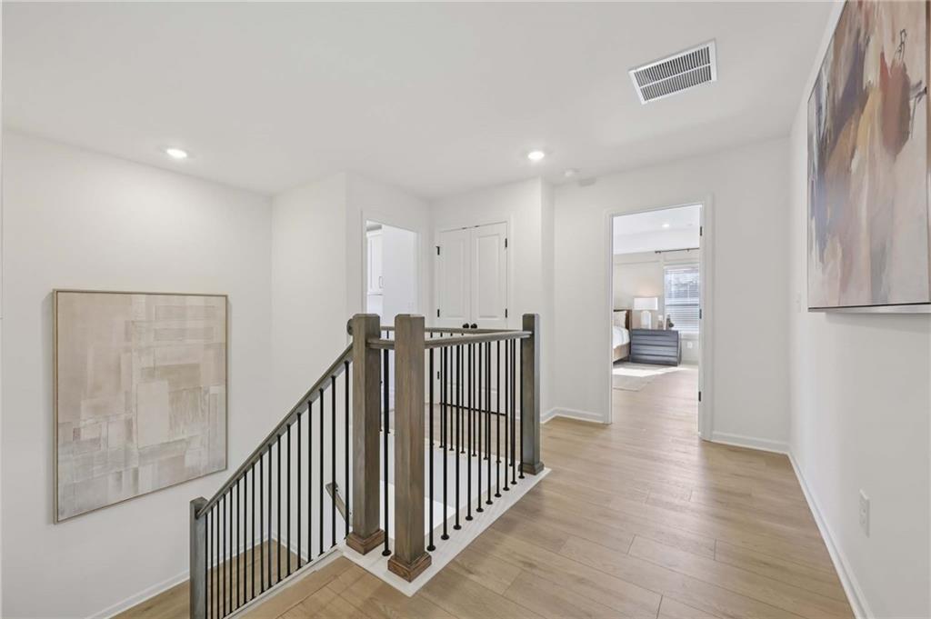 6145 Kismet Road Buford, GA 30518 - Photo 25 of 43 a view of a hallway with wooden floor and staircase