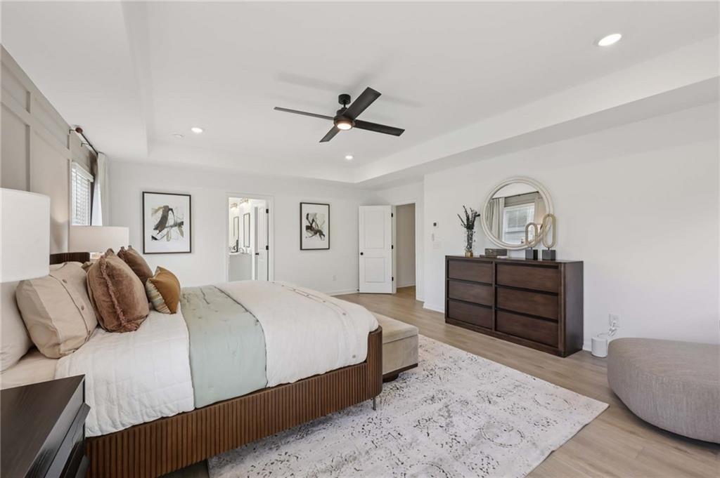 6145 Kismet Road Buford, GA 30518 - Photo 36 of 43 a bedroom with a bed and wooden floor