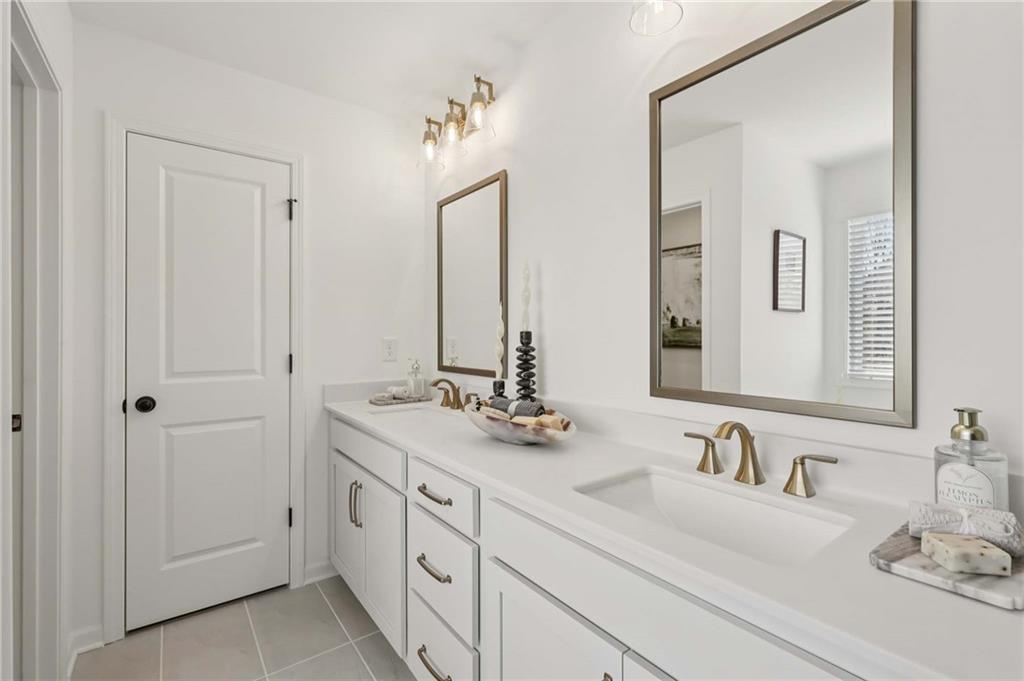 6145 Kismet Road Buford, GA 30518 - Photo 39 of 43 a bathroom with double vanity sinks and a mirror