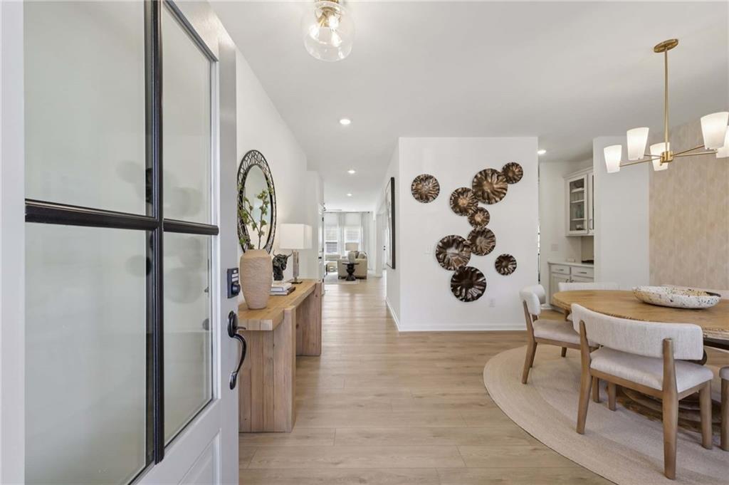 6145 Kismet Road Buford, GA 30518 - Photo 5 of 43 a dining room with furniture and wooden floor