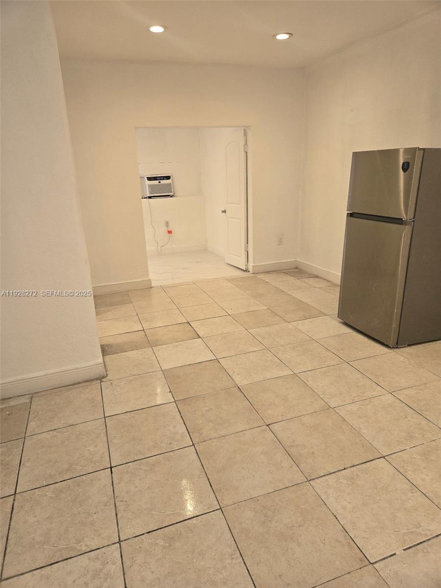 2614 Southwest 8th Street, Unit 5 Miami, FL 33135 - Photo 1 of 1 a view of a refrigerator in kitchen and an empty room