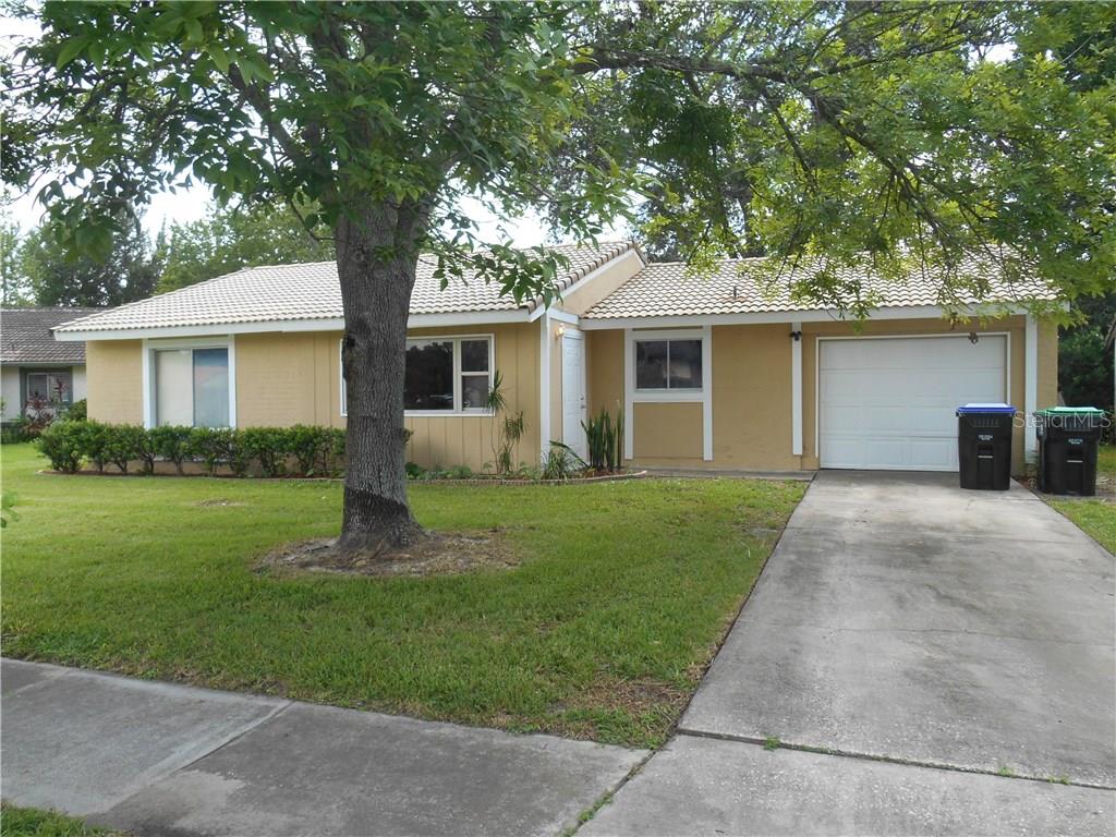 a front view of house with yard and green space