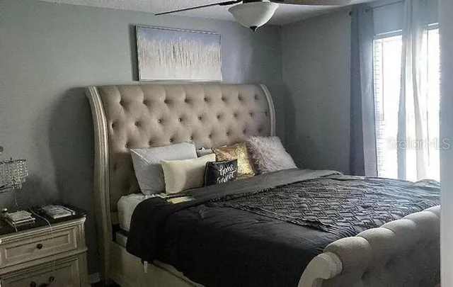 a bedroom with a bed and window